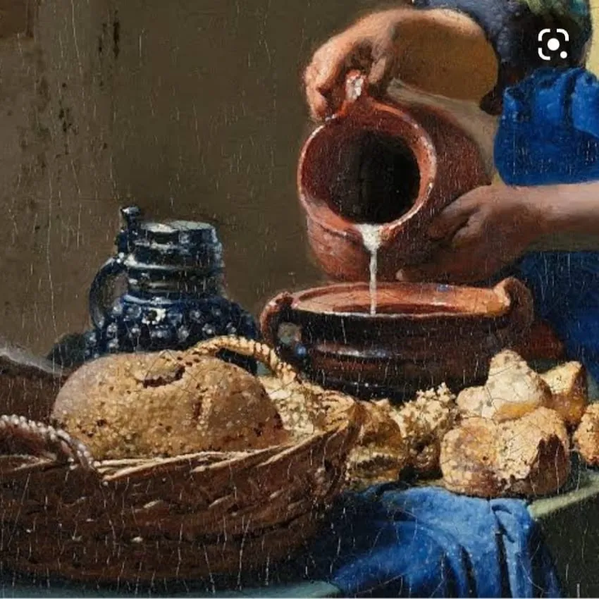 Detalhe da mesma pintura: o fio de leite caindo da jarra, ao lado do cesto de pães